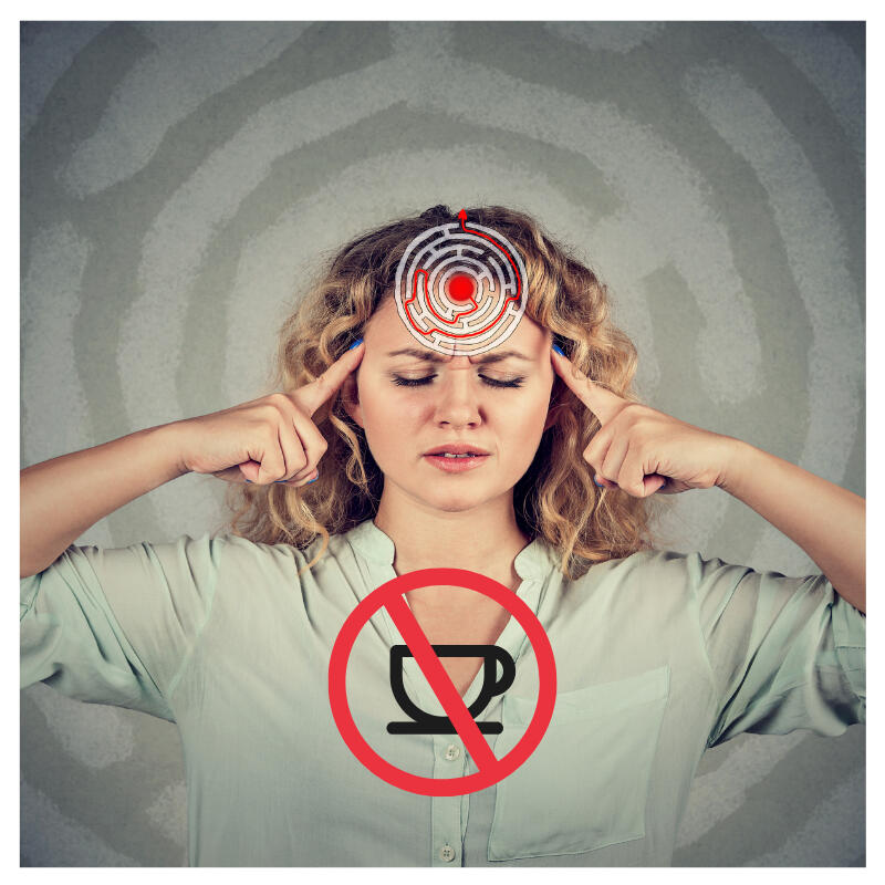 A woman pressing her temples with no caffeine sign - Best Nootropic for Focus Without Caffeine